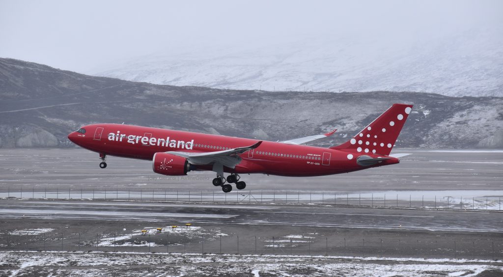 Air Greenland Boeing aircraft, in red livery, taking off.