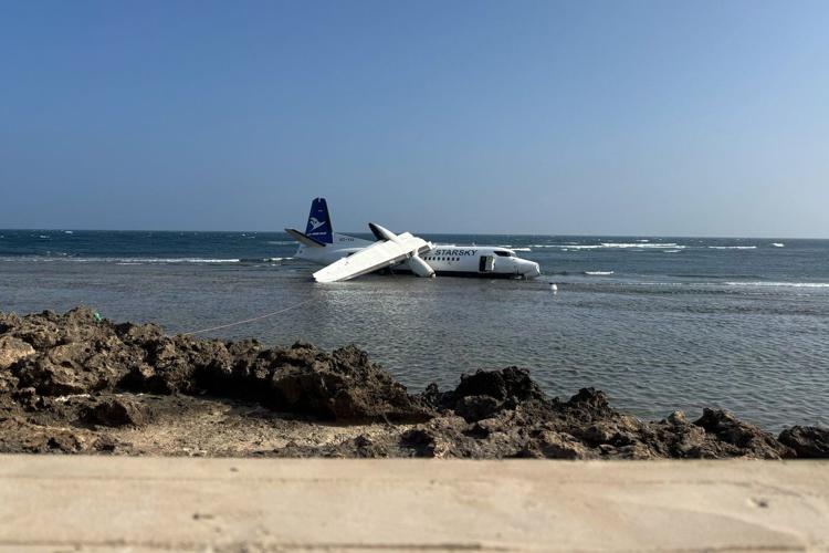 The Fokker 50 remains situated on the shore