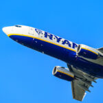 A Ryanair Boeing 737 in mid-flight, blue sky.