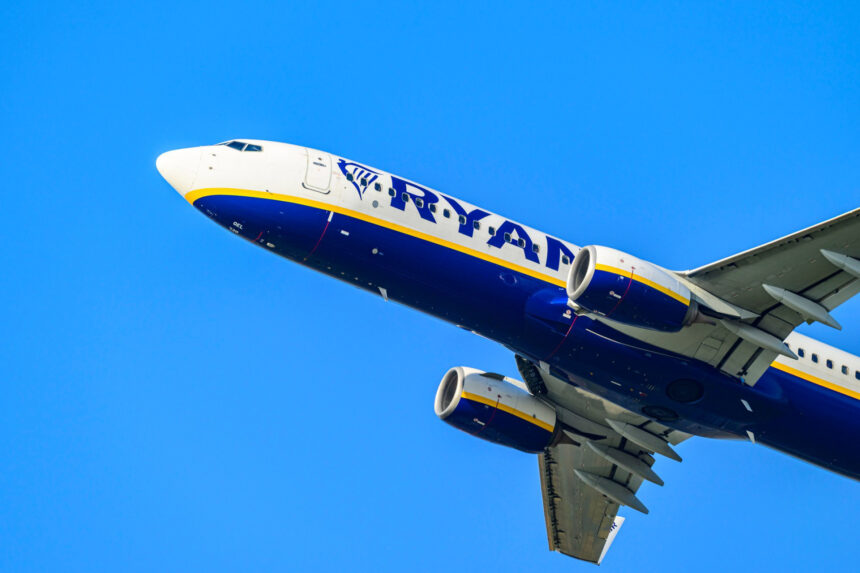 A Ryanair Boeing 737 in mid-flight, blue sky.