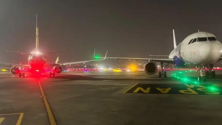 Runway lights and A320 wingtips are seen after a minor collision at Mumbai Airport; passengers evacuated safely as DGCA investigates.