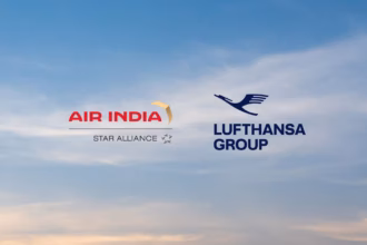 An image from the press release of the announcement of Lufthansa Group expanding their strategic partnership with Air India. the background is of a sunrise with the two airline logos floating in the middle.