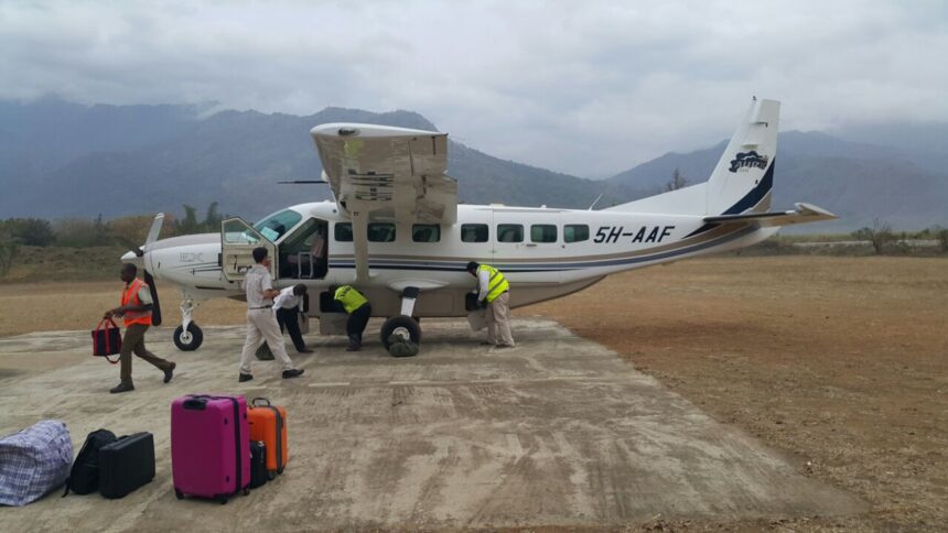 An Auric Air Services Cessna 208B Grand Caravan aircraft being inspected by its crew.