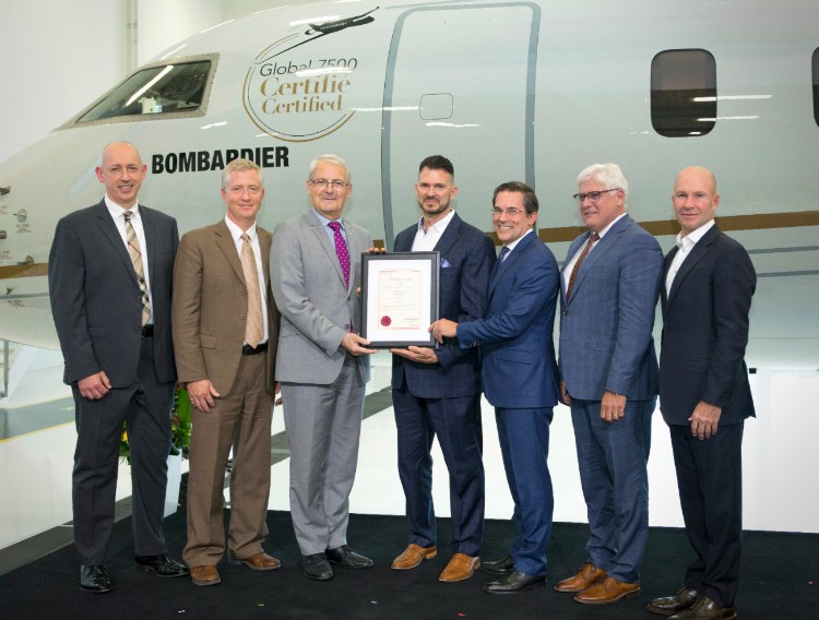 Bombardier executives stand in front of a Bombardier Global 7500 aircraft holding a certification document, highlighting aircraft certification in Canada.