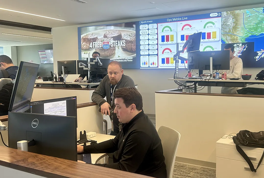 Republic Airways training center, men on computers in an office building.