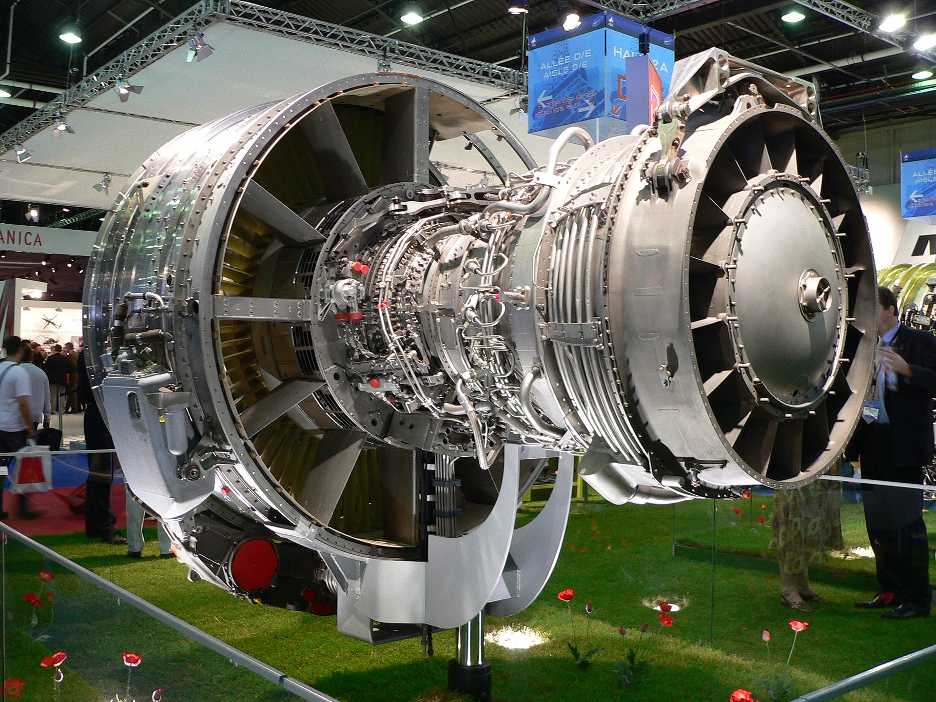 A close-up side view of a large commercial jet engine, the CFM56, mounted on a stand in a maintenance facility.