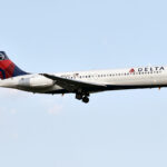 Delta Airline's Boeing 717 in flight against blue skies