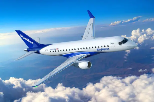 Embraer E175 SkyWest aircraft flying in the blue sky, with clouds.