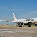 A Starlux Airlines Airbus A330-941 on an airport runway.