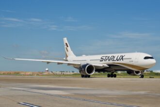 A Starlux Airlines Airbus A330-941 on an airport runway.