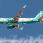 Flynas aircraft A320neo flying in the blue sky.