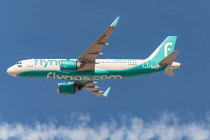 Flynas aircraft A320neo flying in the blue sky.
