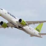 An airBaltic Airbus A220-300 in mid-flight.