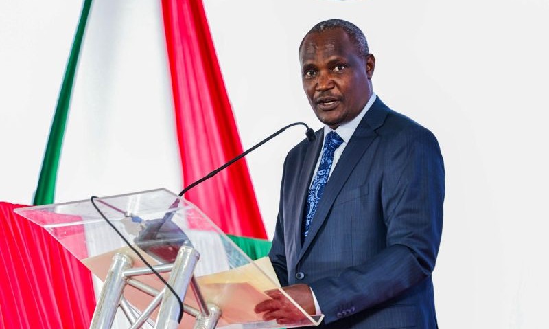 Finance Minister John Mbadi speaking at podium at the Nairobi Securities Exchange.