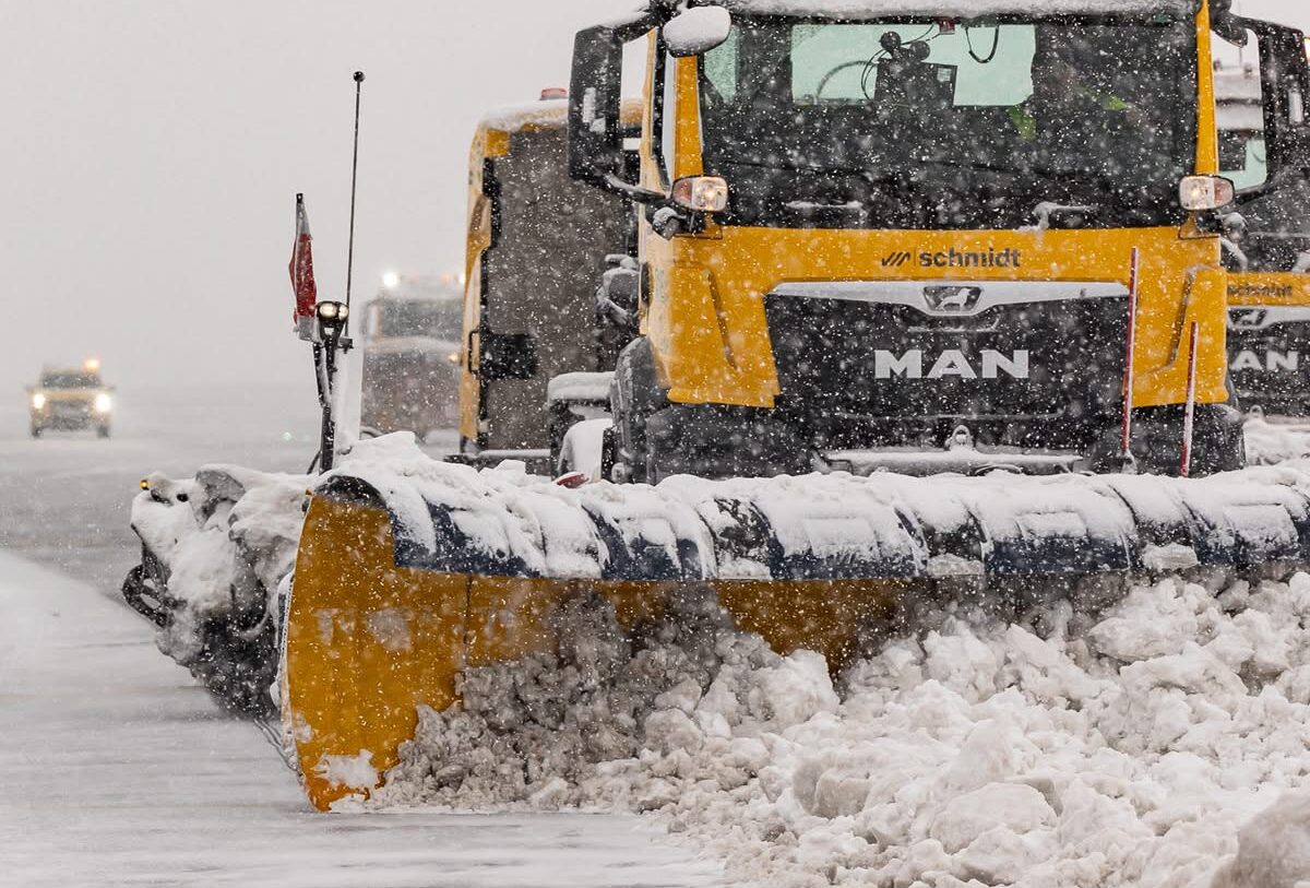 This image depicts a vehicle moving the snow aside