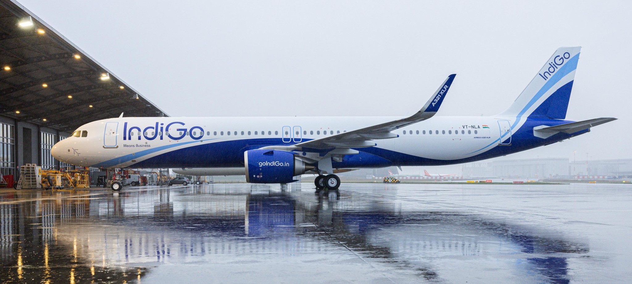 IndiGo Airbus A321-XLR aircraft on the tarmac before boarding. Raining.