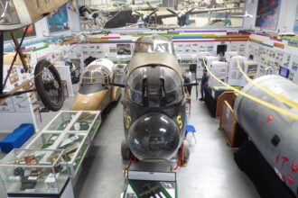 Interior of the Avro Heritage Museum at Woodford, showing aircraft nose sections and exhibits as part of the Avro Heritage Museum expansion and Avro aircraft preservation in the UK.