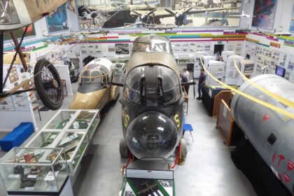 Interior of the Avro Heritage Museum at Woodford, showing aircraft nose sections and exhibits as part of the Avro Heritage Museum expansion and Avro aircraft preservation in the UK.