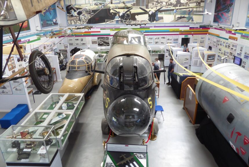 Interior of the Avro Heritage Museum at Woodford, showing aircraft nose sections and exhibits as part of the Avro Heritage Museum expansion and Avro aircraft preservation in the UK.