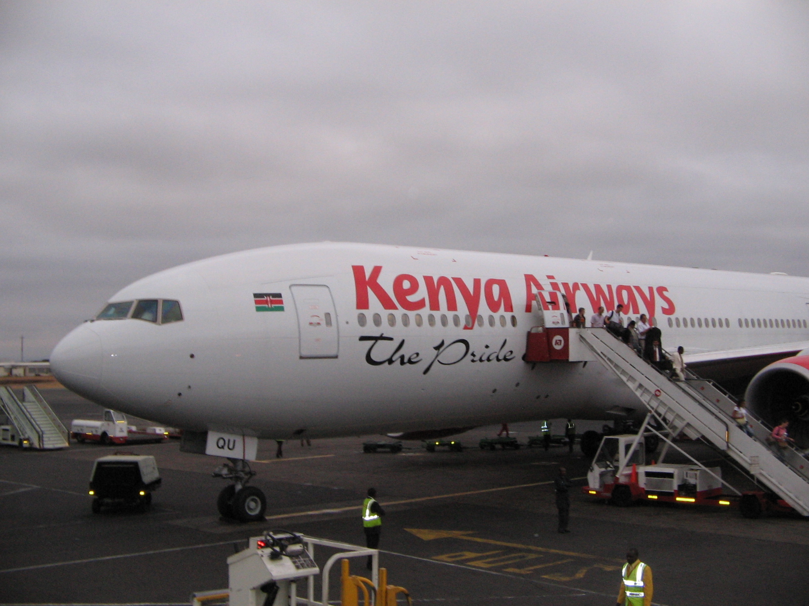 Kenya Airways Boeing 777-2U8/ER aircraft (5Y-KQU) parked at Jomo Kenyatta International Airport. Passengers disembarking through the stairwell. 