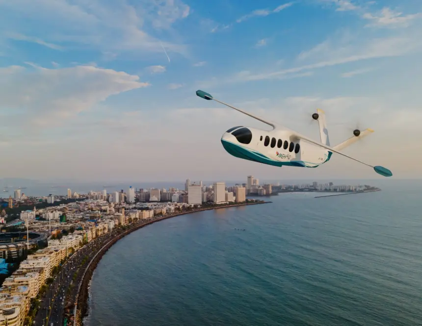 Mehair aircraft flying over the sea with a city in the left background.