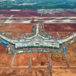 Long Thanh Airport construction showing terminal building and runway works supporting Vietnam aviation growth and the Vietnam aviation industry 2026.