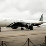 Magnifica Air Airbus on the tarmac, clouds in the background.