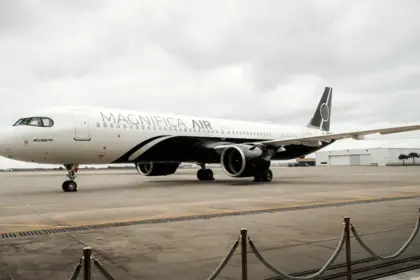 Magnifica Air Airbus on the tarmac, clouds in the background.