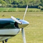 small airplane, grass in background.