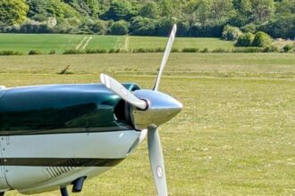 small airplane, grass in background.
