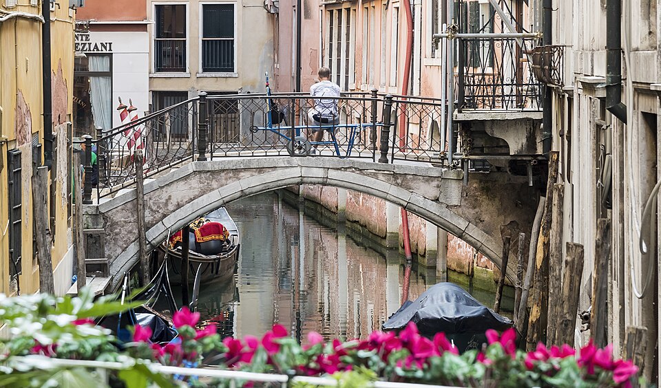 Venice narrow canal, gondolas, and traditional buildings