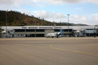 The exterior at Port Moresby International Airport showing tarmac and small jet