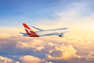 Qantas A320 aircraft in flight above clouds