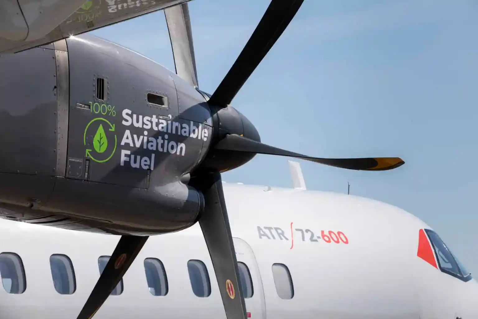 Close-up of an ATR 72-600 turboprop aircraft engine marked 'Sustainable Aviation Fuel' on the nacelle.