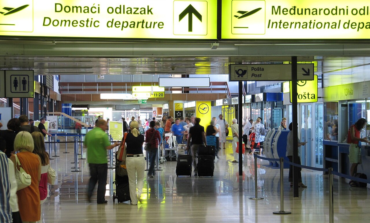 Zagreb airport interior, busy terminal, signs for domestic departure.