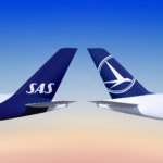 An image of two aircraft tails that belong to SAS and TAROM