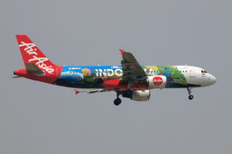 Indonesia AirAsia Airbus A320-200 flying in the air