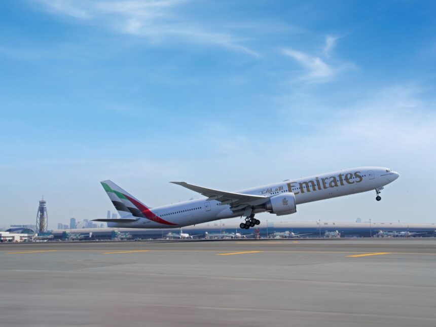 An Emirates Boeing 777-300ER aircraft in new livery taking off from Dubai International Airport runway.