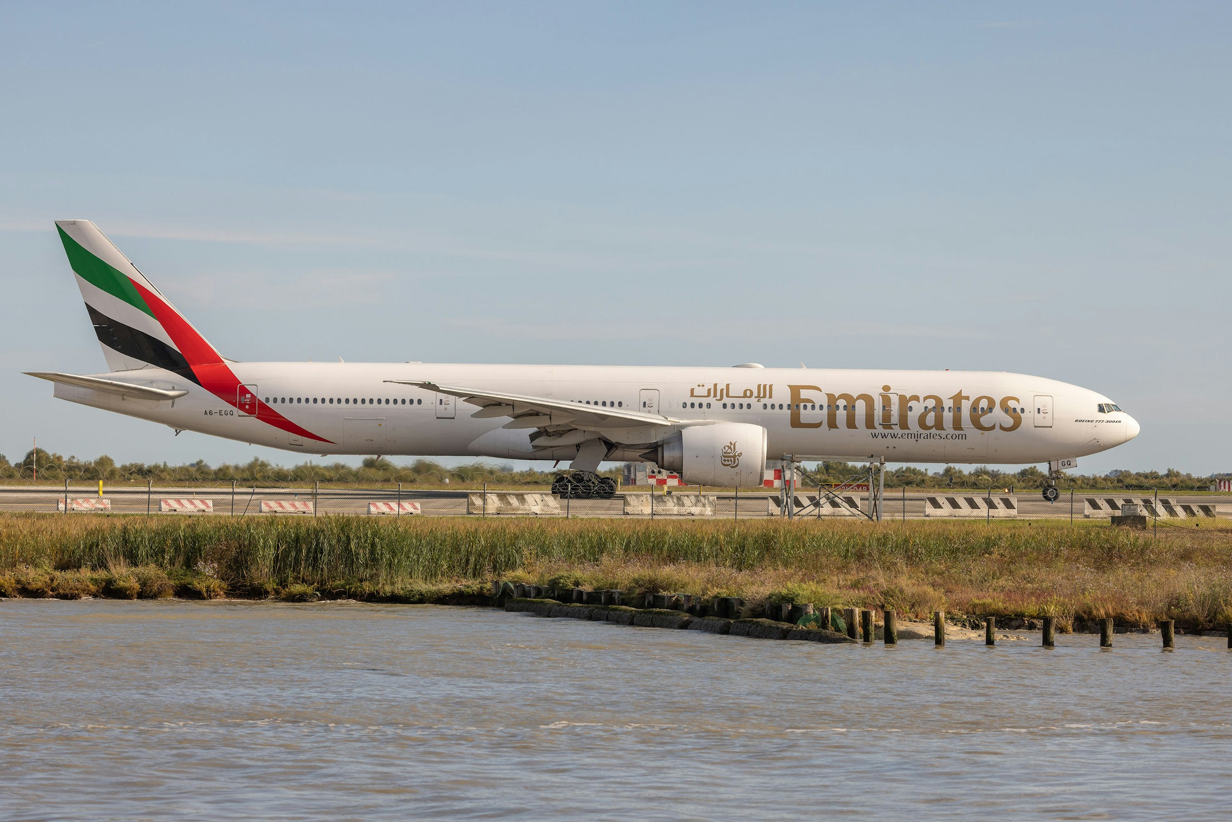 Boeing 777 of the airline Emirates at the Marco Polo Airport in Venice on roll-by, side view throughout its extension.