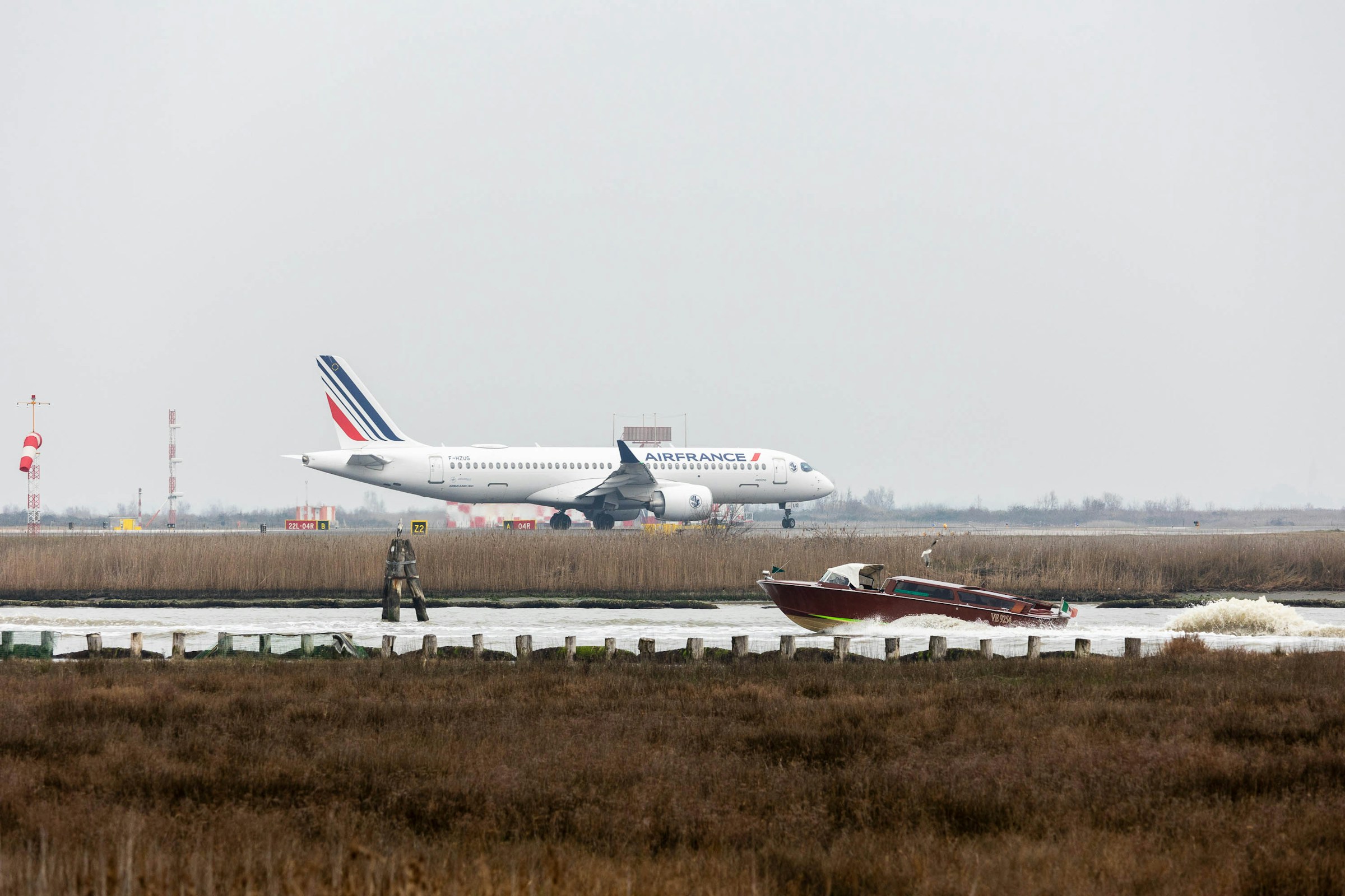 Airline of a French company landing with landing gear extracted. Venice Marco Polo Airport (VCE), Viale Galileo Galilei.