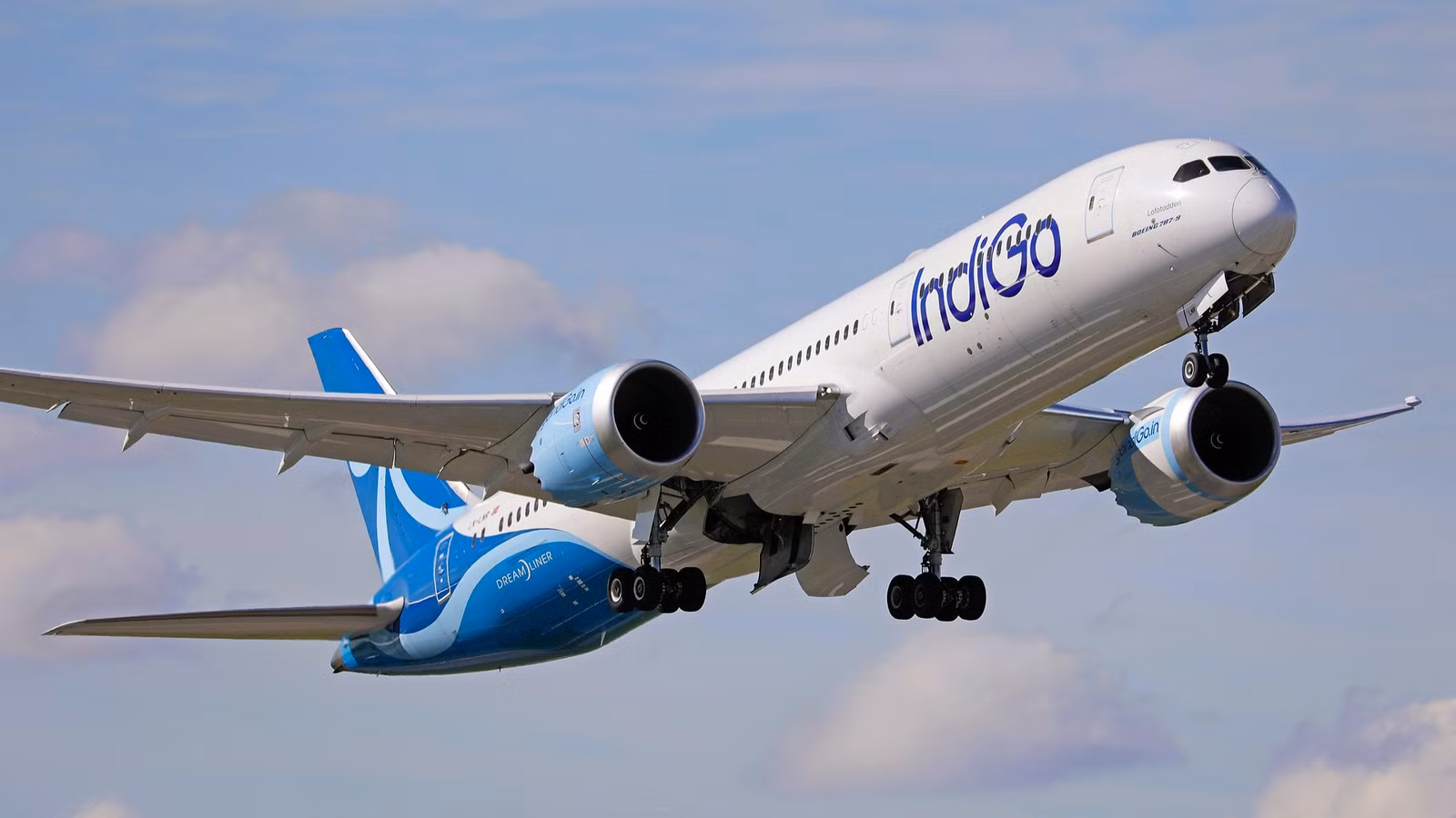 IndiGo Boeing Dreamliner aircraft flying in blue sky.