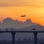 Airplane Silhouette Against Vibrant Sunset Sky