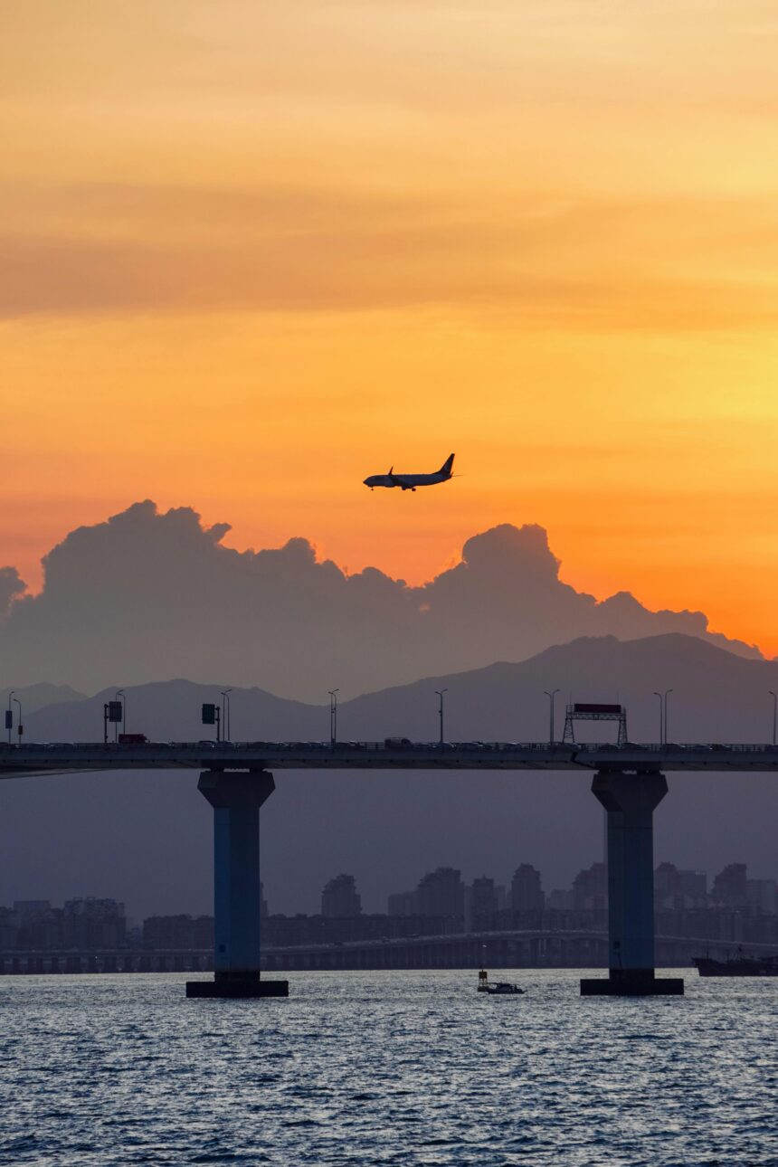Airplane Silhouette Against Vibrant Sunset Sky