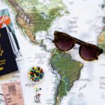 A map of USA with sunglasses and a passport on top of it.