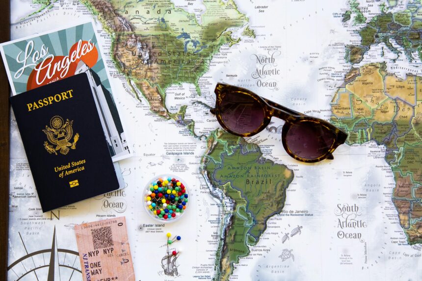 A map of USA with sunglasses and a passport on top of it.