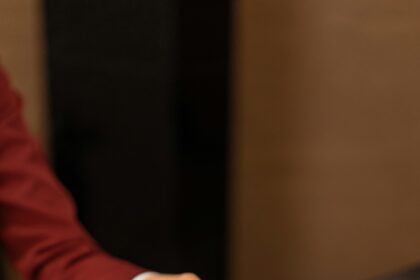 A Hotel Receptionist Handing a Key Card to a Guest