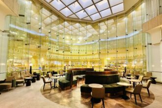 An interior airport lounge bathed in yellow lights.