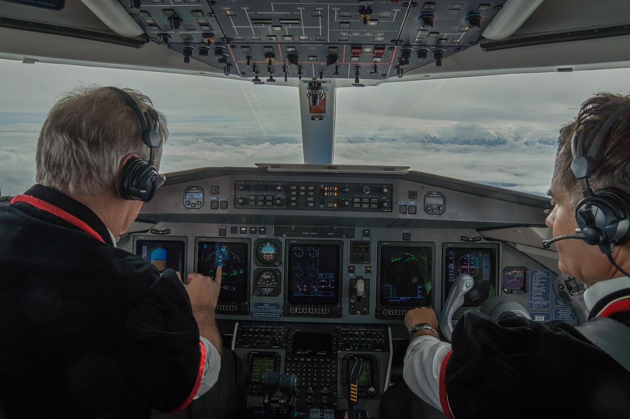 The image depicts pilots seated in the cockpit