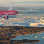 Illustrated of an Air Greenland Airbus, flying over land and water.