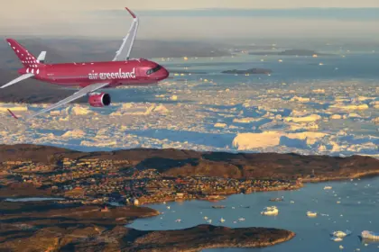 Illustrated of an Air Greenland Airbus, flying over land and water.